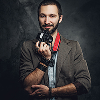 man-is-posing-for-photographer-with-photo-camera-K7AK6SN